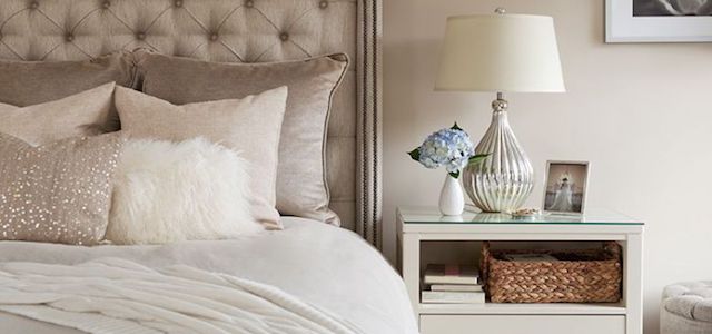 A neutral bedding set in a luxury master bedroom.