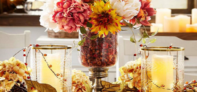 A dining room table centerpiece with twinkle lights and fall flowers.