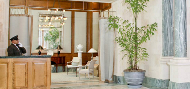 The interior of Glenwood's luxury apartment building in Manhattan with a marble lobby and doorman services.