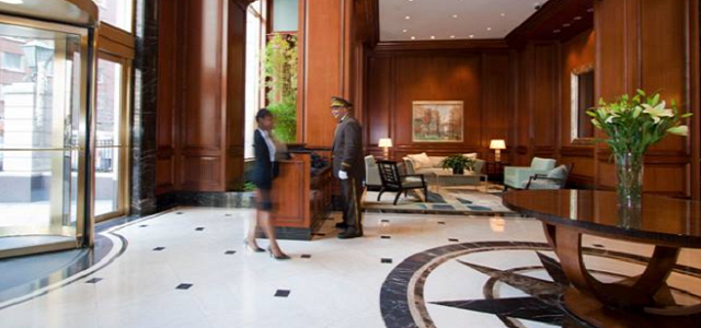 The interior of a Glenwood apartment building in New York City with wooden features and doorman services.