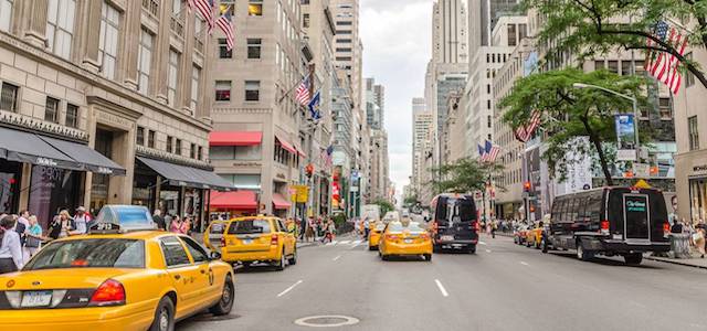 A busy street in Midtown East Manhattan with yellow taxi cabs.