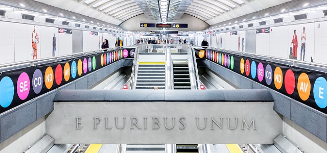 An interior view of the Second Avenue Subway station in New York City with colorful wall decor.