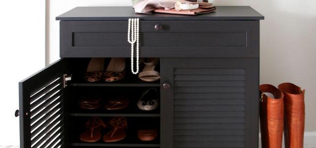 A grey colored wooden cabinet with secret shoe storage.