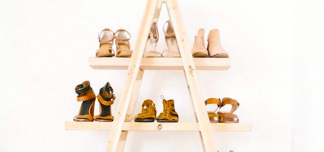 A triangular wooden shoe holder.