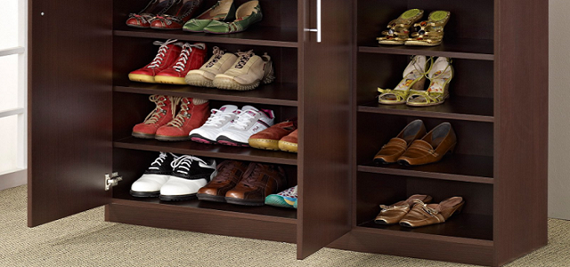 A wooden shelving cabinet with sneakers and boots for storage.