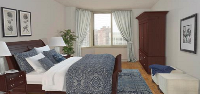 A view of luxury bedding and room decor inside of Glenwood's The Brittany apartment complex in New York City.
