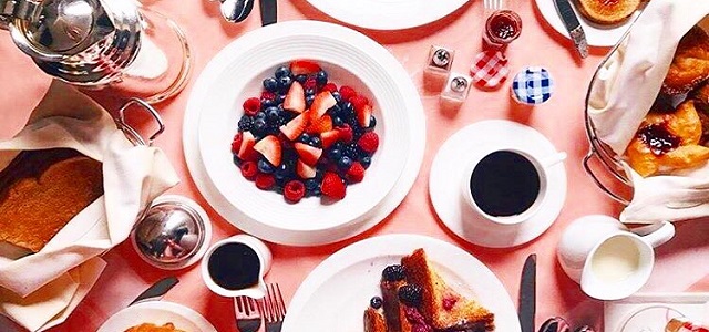 A breakfast table at The Carlyle Hotel in NYC with fresh fruit and coffee.
