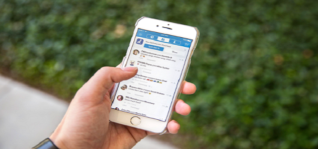 A man holding an iPhone with the Venmo app downloaded to send money.