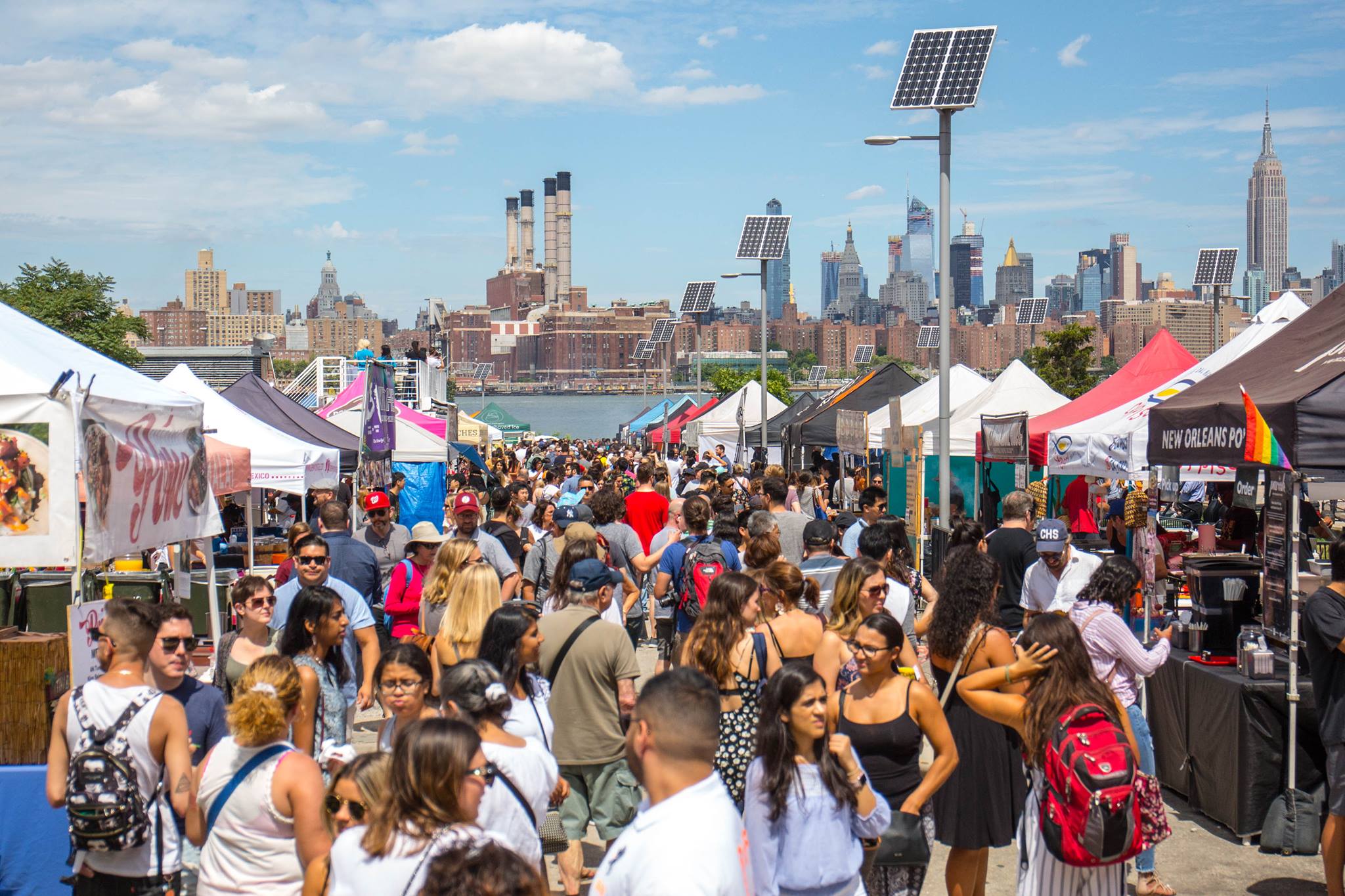 Group of adults walking the food vendor tents of Smorgasburg