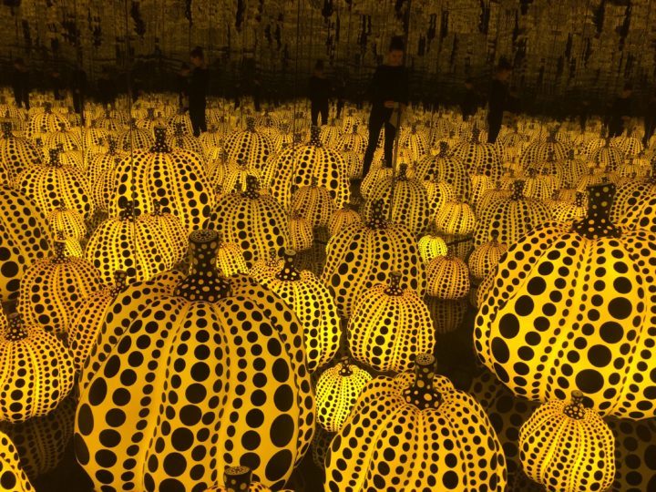 Artist Kusama's famous dotted pumpkins in a dark room