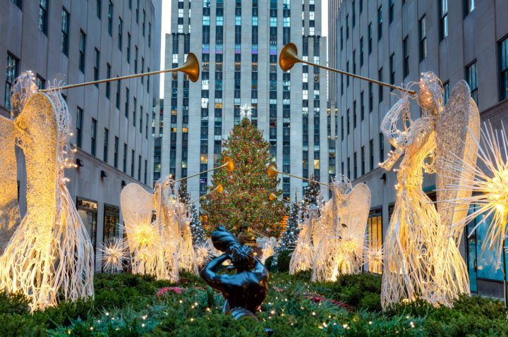 Rockefeller Center Christmas tree surrounded by angel sculptures