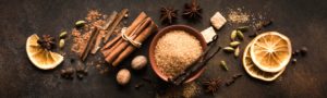 Fall and winter scents like cinnamon, and clove spread out on a table 