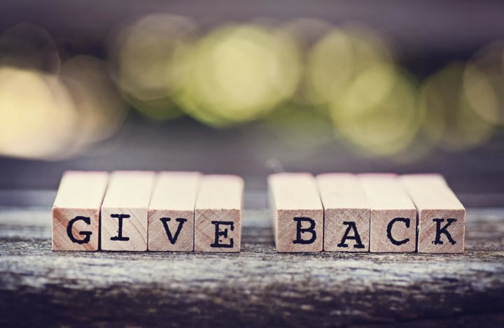 Letter blocks that spell out Give Back