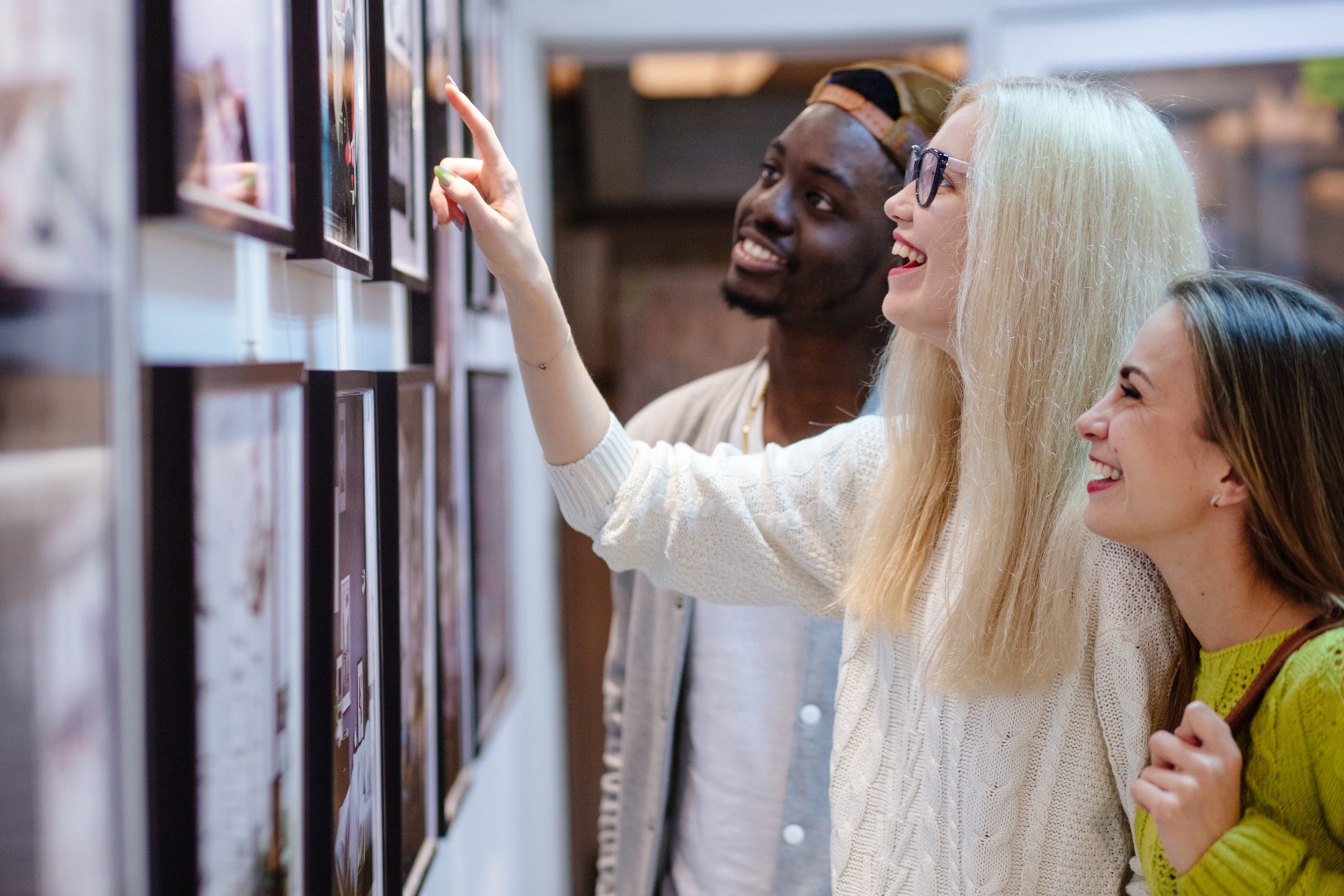 A group of friends looking at art in an exhibit