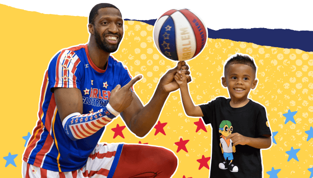 A child spinning the basketball with a Harlem Globetrotter
