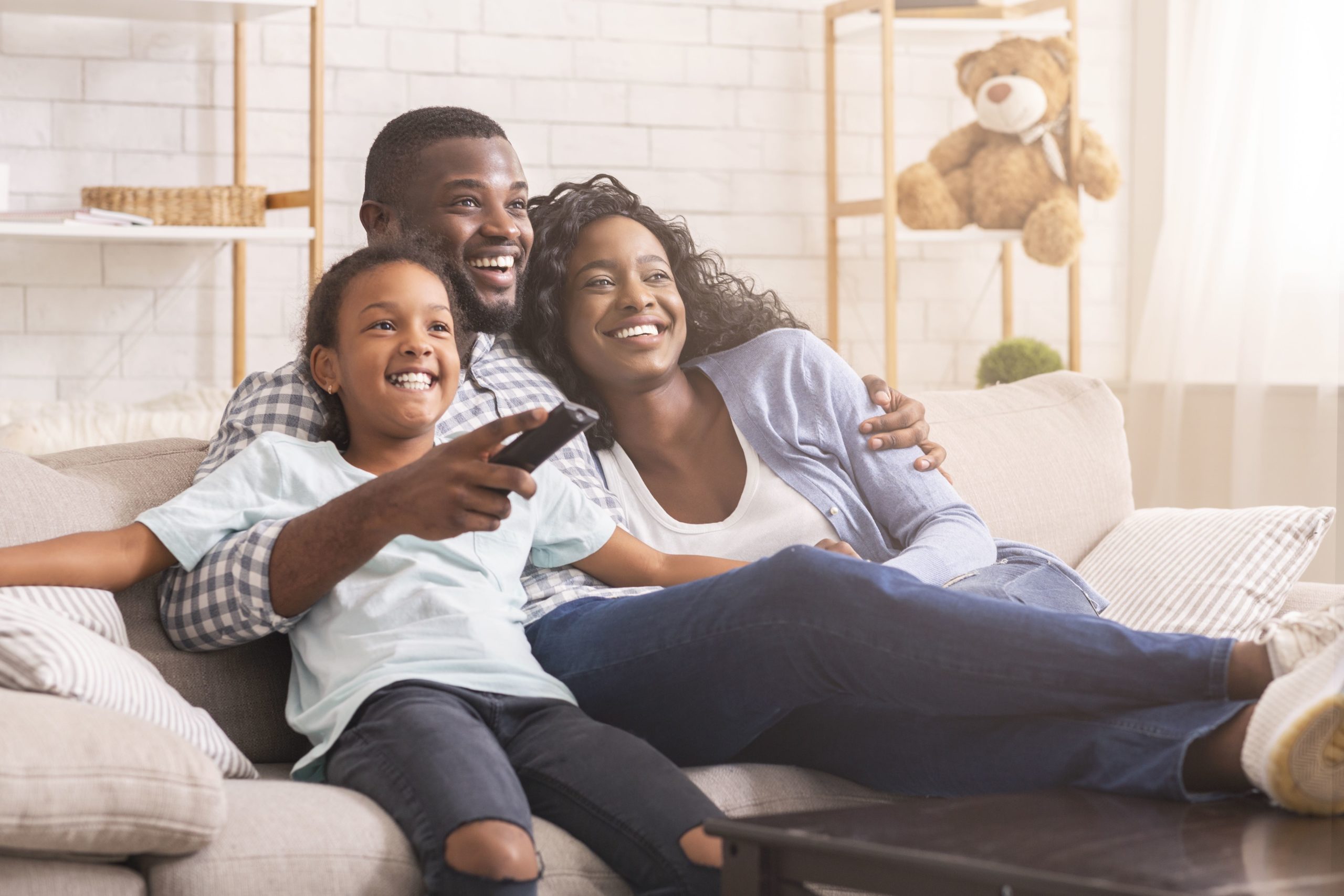 A family on a couch watching tv