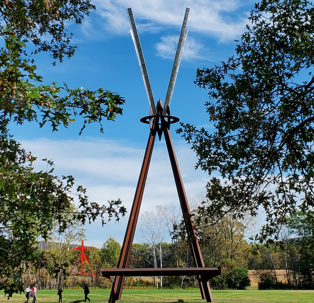 photo of a calder iron sculpture on a grass field