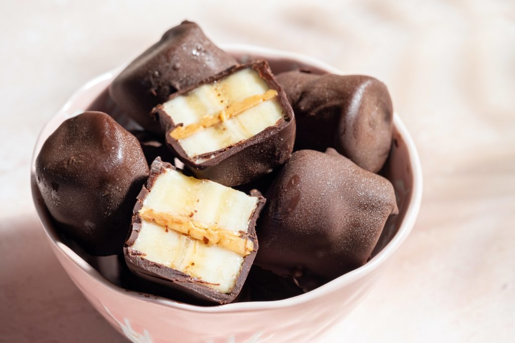 Chocolate covered banana bites sitting in a bowl