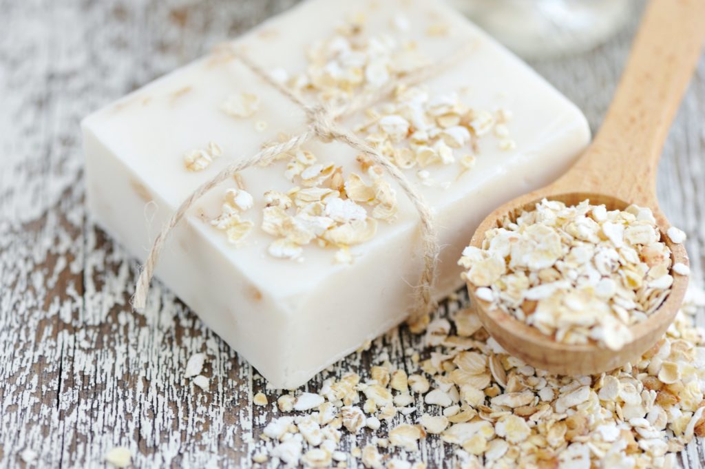 Oats in a spoon and on a soap block