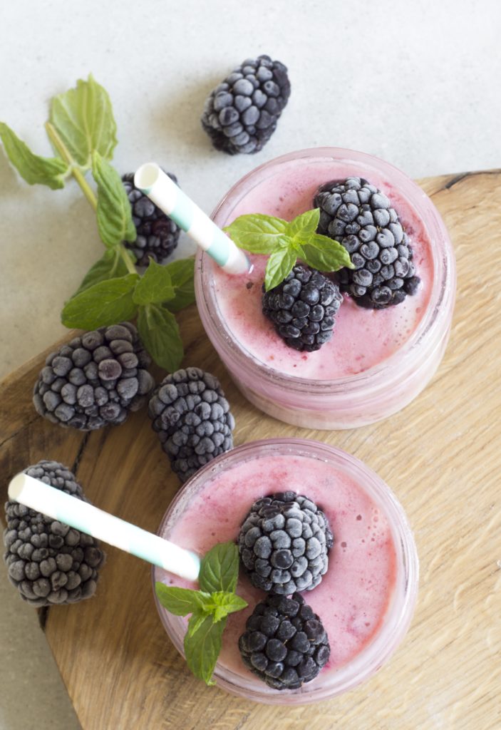 A smoothie with blackberries placed on top