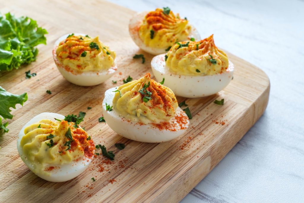 Deviled eggs on a wooden board