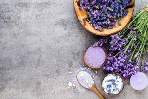 Essential lavender salt with flowers top view.