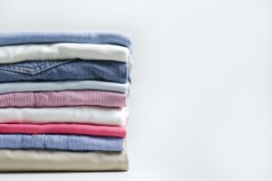 Folded clothing against a white background