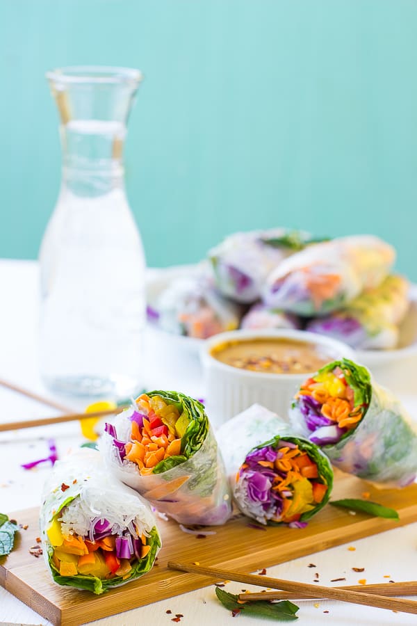 Spring rolls with peanut sauce on a tray with a blue background