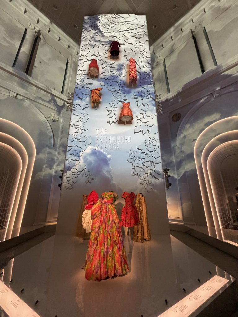 A wall display of Dior Dresses in warm color tones