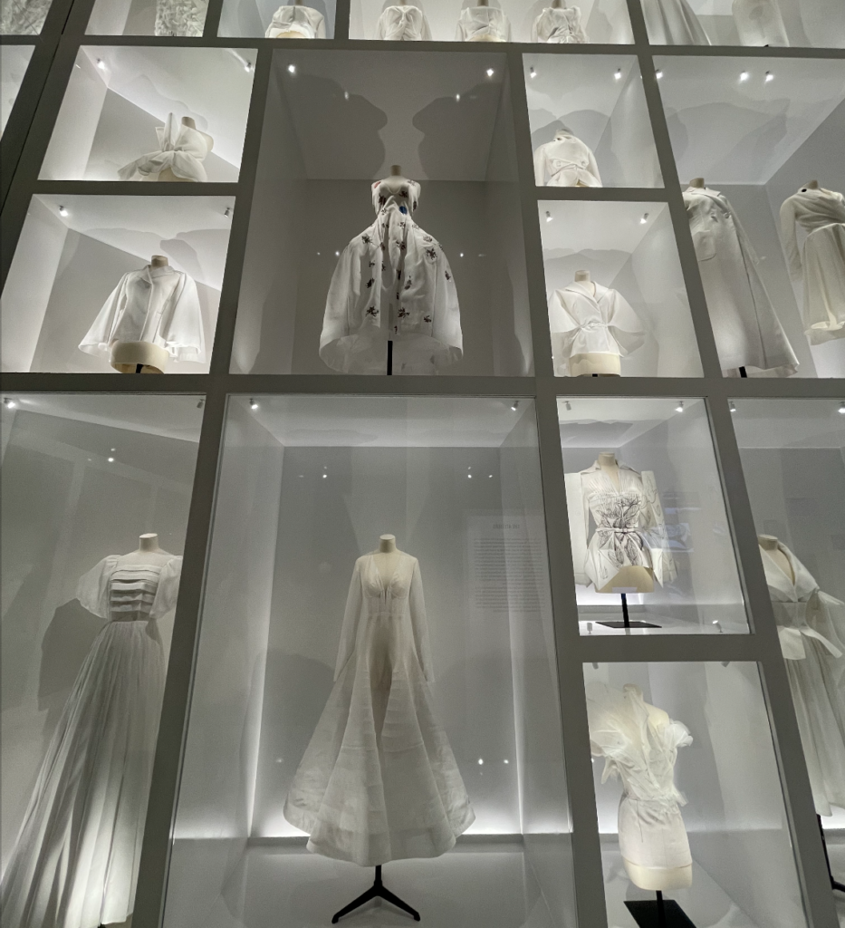 Entire wall of Christian Dior dresses in a white display