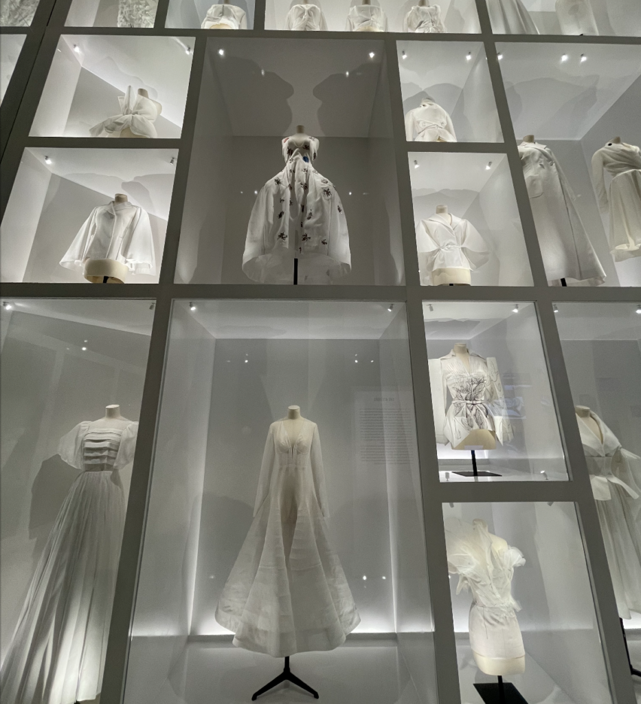 Entire wall of Dior dresses in a white wood display