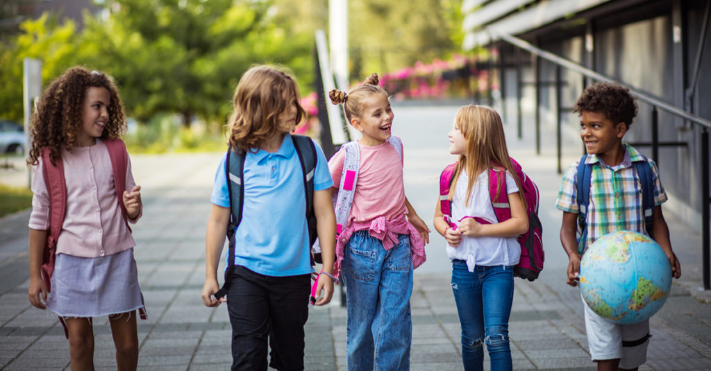 5 kids with backpacks walking to school in NYC 