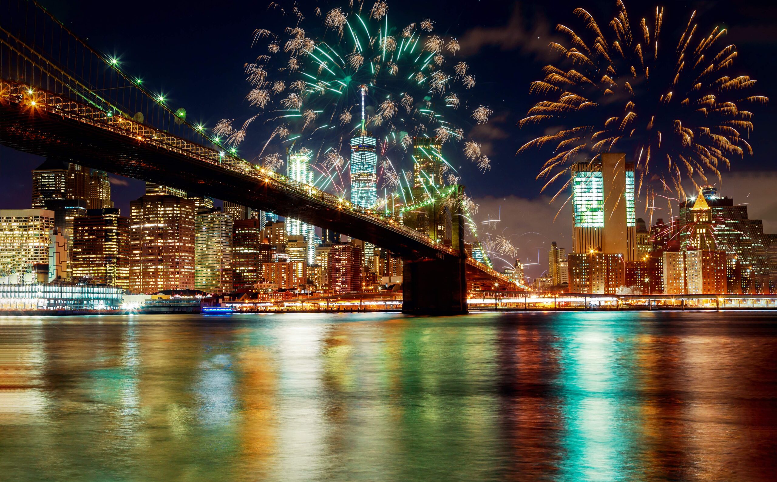 Brooklyn Bridge and Manhattan skyline illuminated at amazing fireworks in Independence day New York City