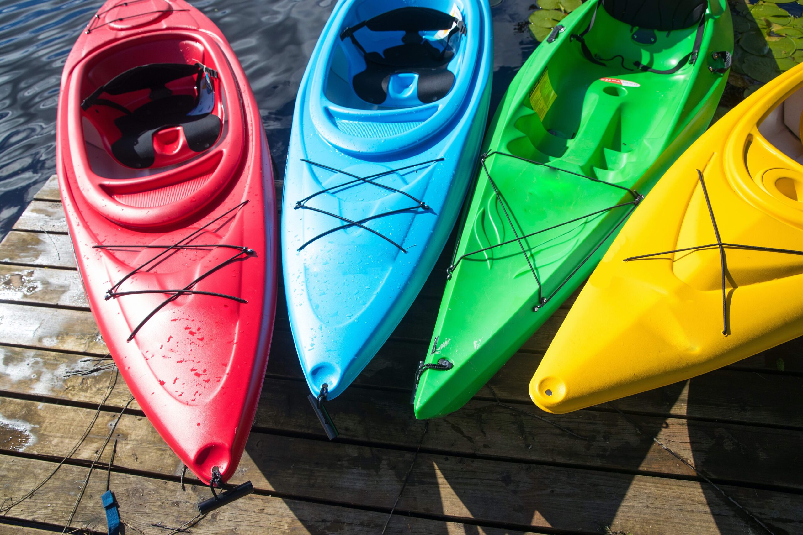 multicolored kayaks on a deck 