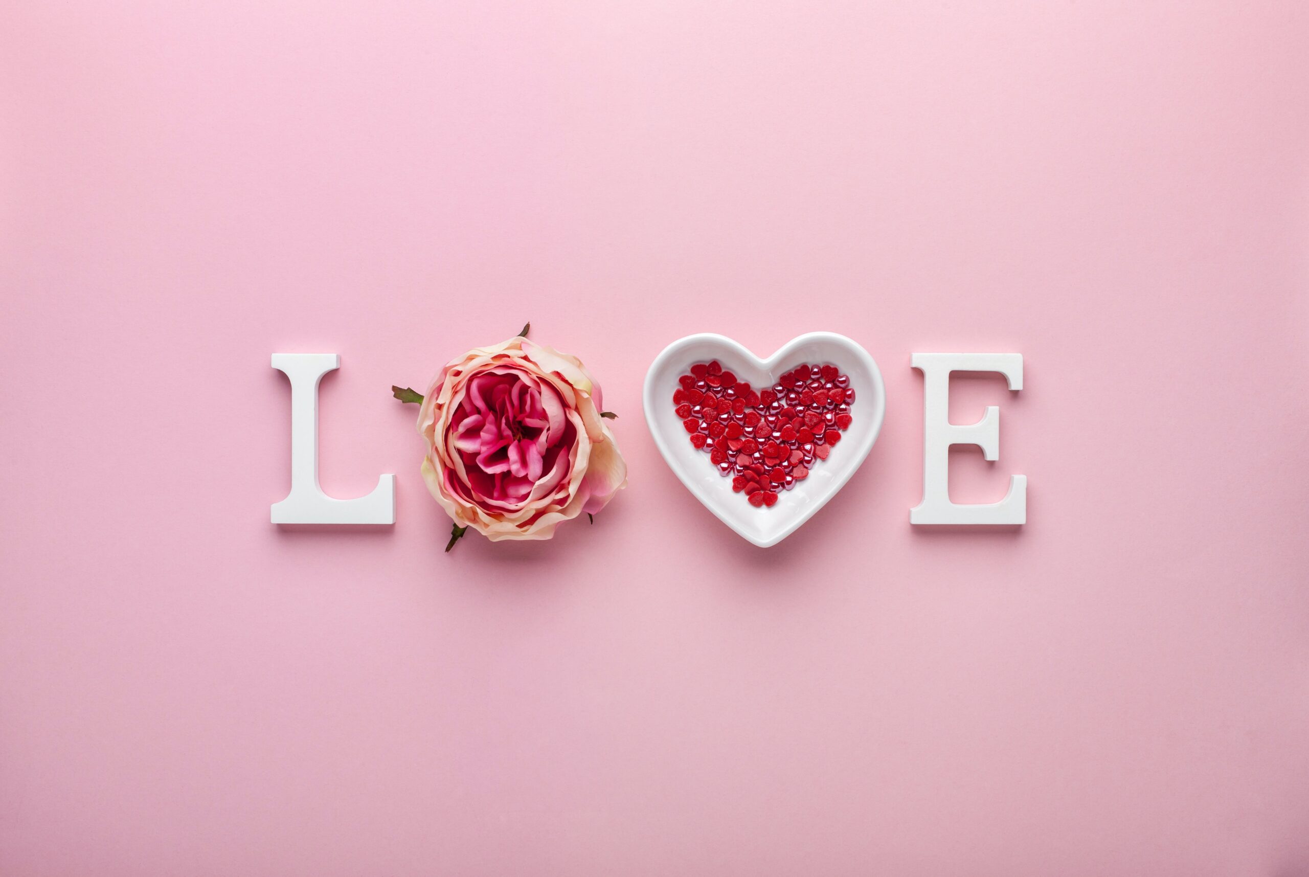 The word love spelt out on pink background