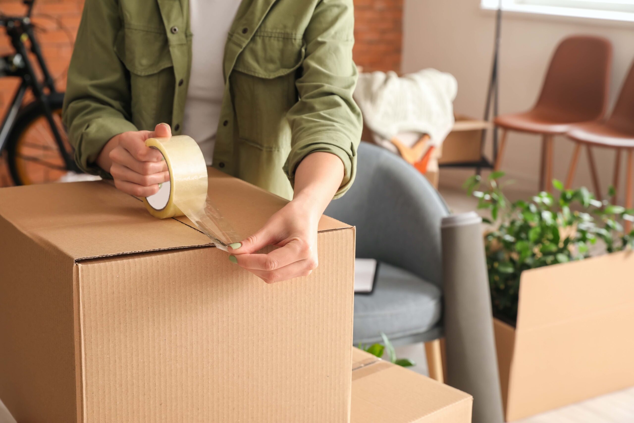 Woman taping up moving box