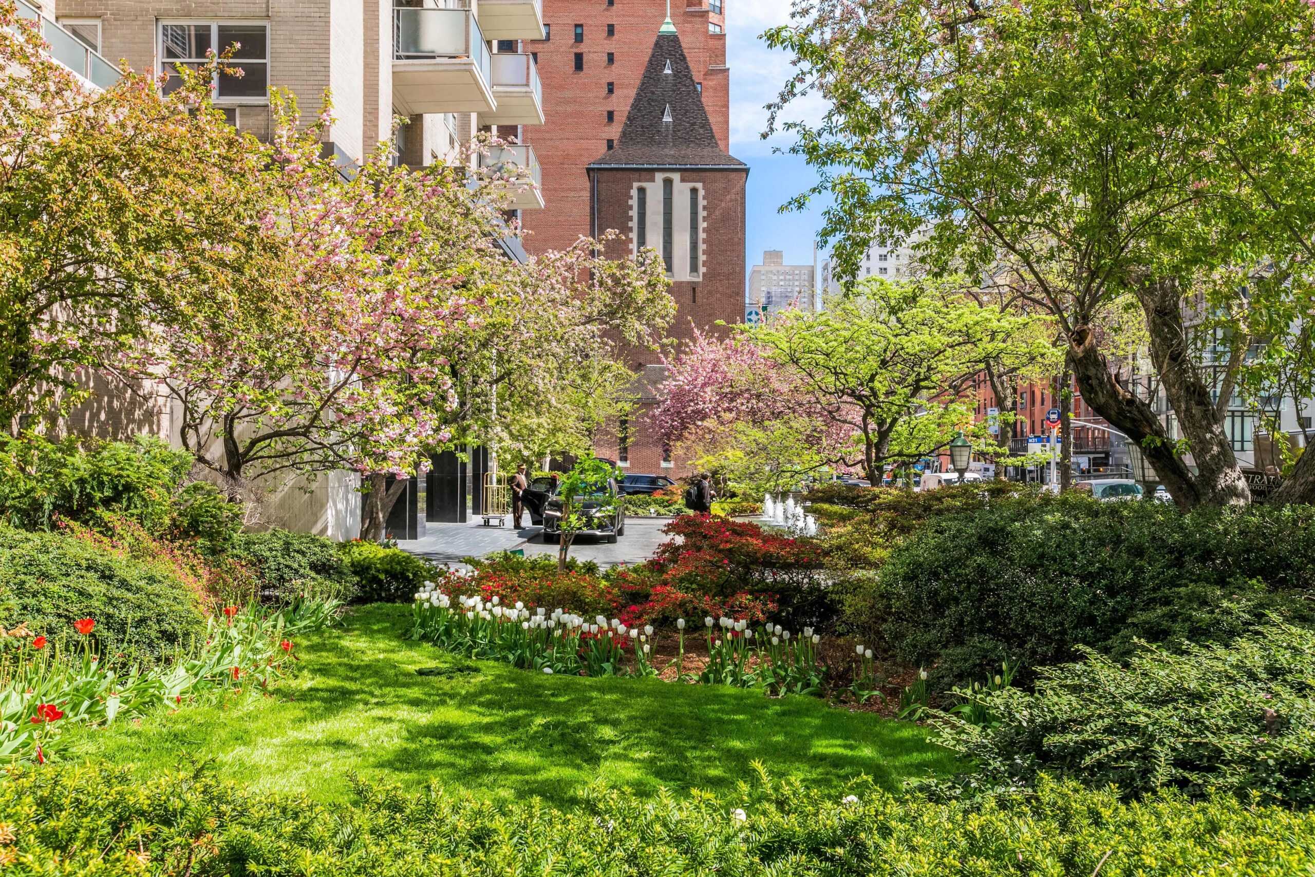 beautiful green landscape, trees, and flowers in front of Glenwood's Stratford building