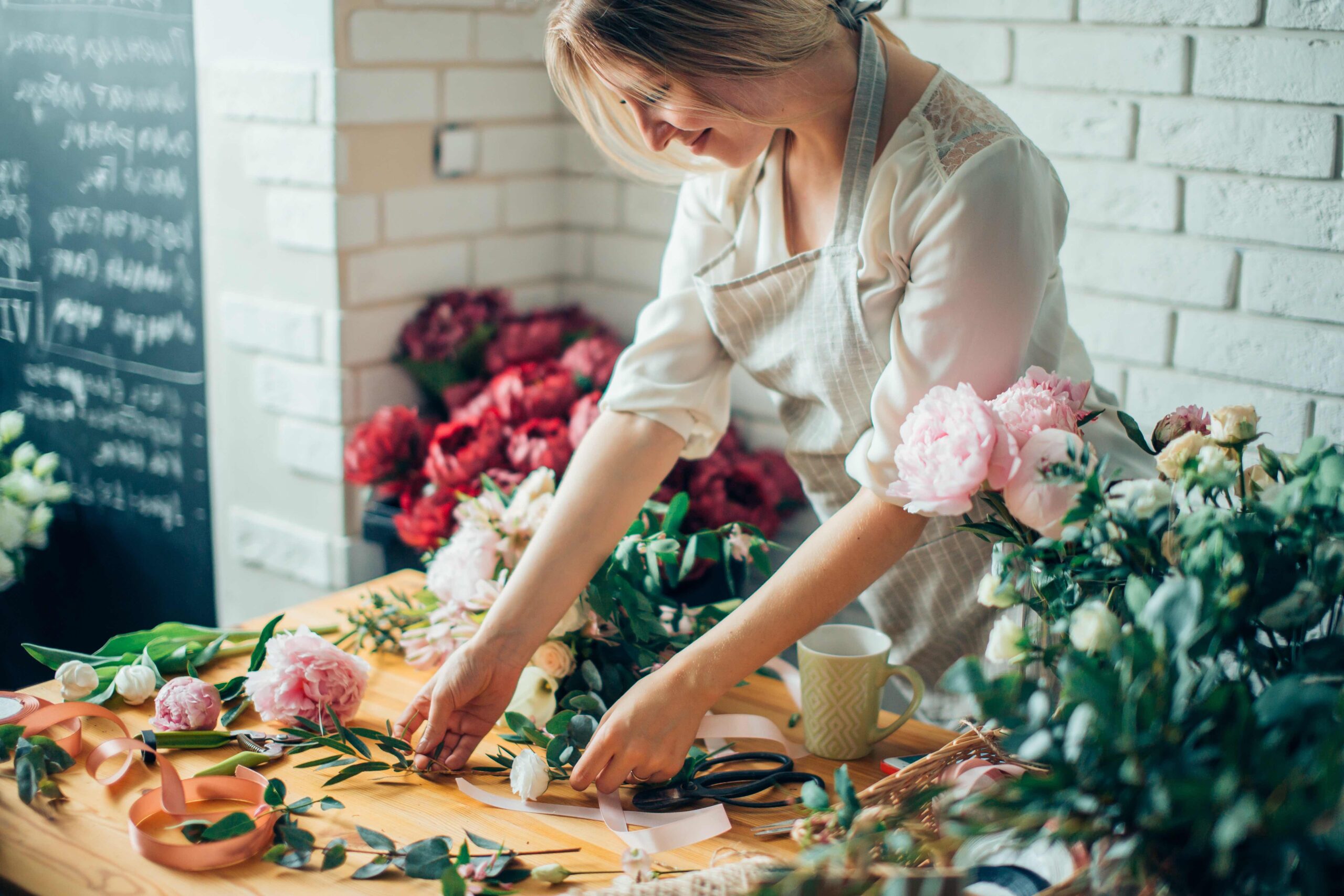Woman making a flower arrangement in a flower shop