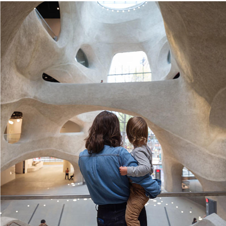 A mother holding her child at the new wing of the Natural History Museum in NYC
