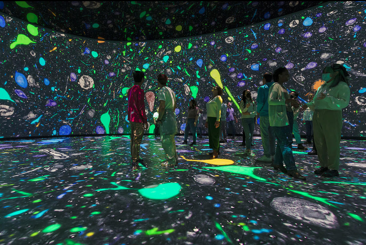 People enjoying an immersive experience exhibit at the Gilder Center