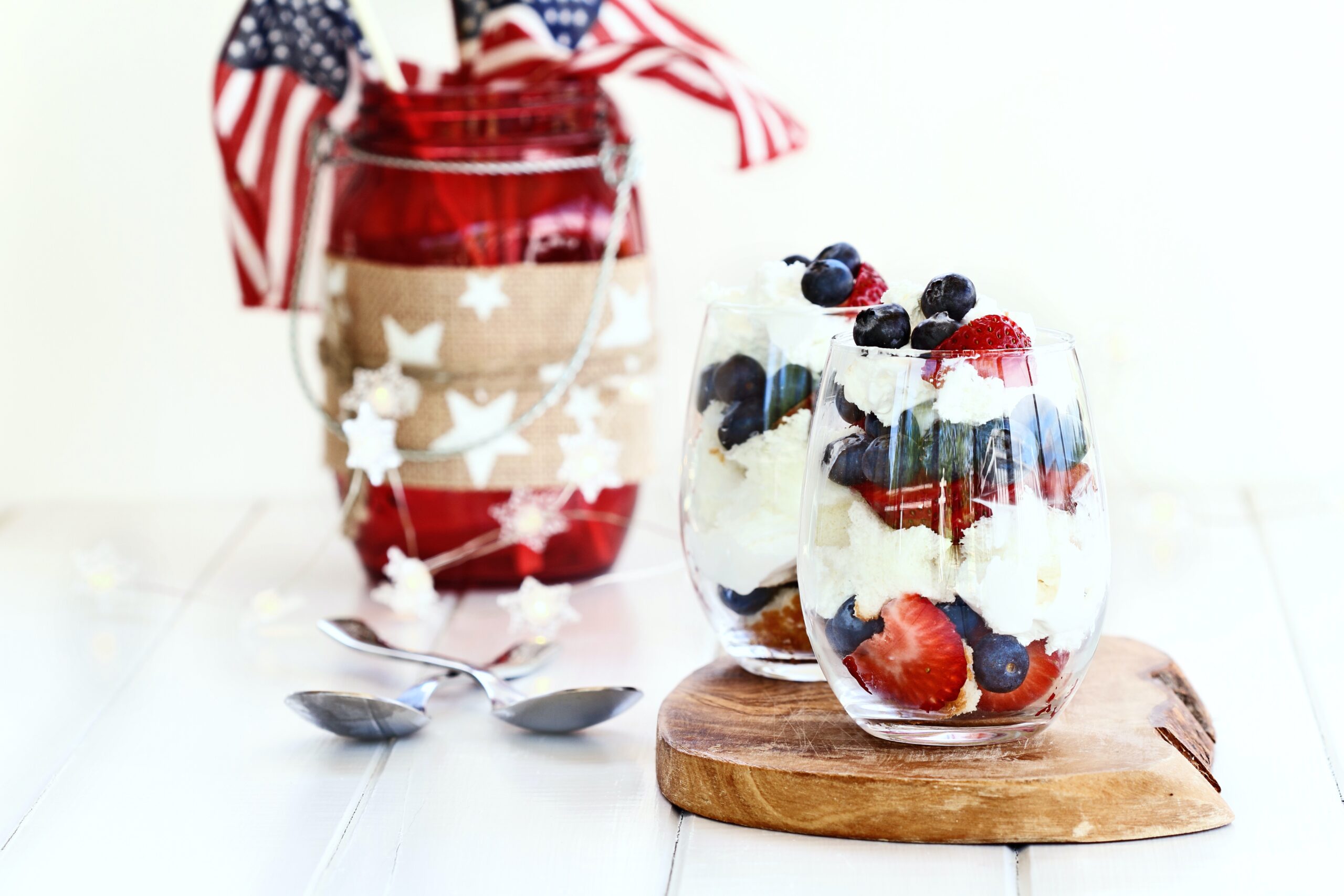 Trifle made with blueberries, strawberries, whipped cream and star shaped pound cake 