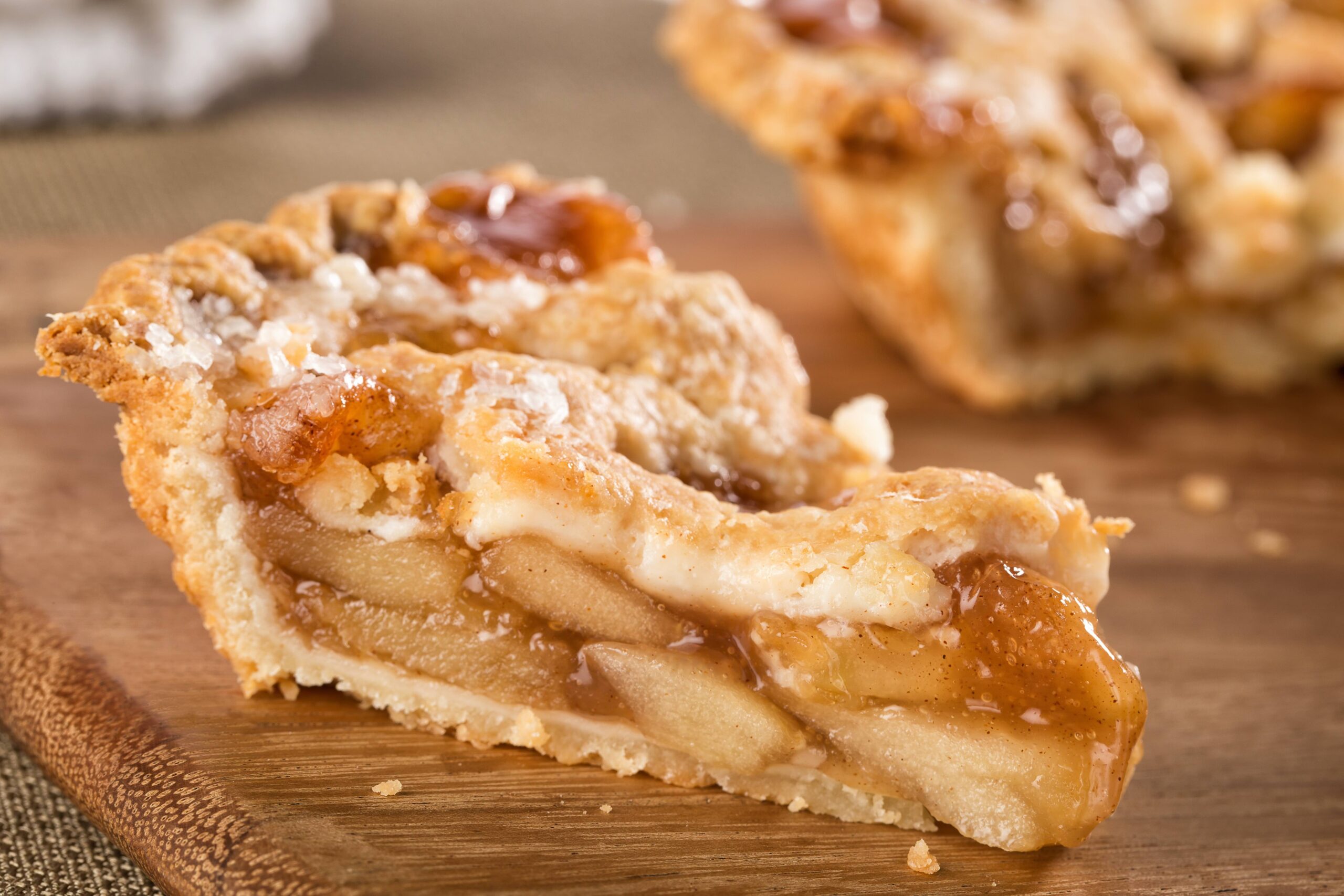 A close up of a slice of apple pie