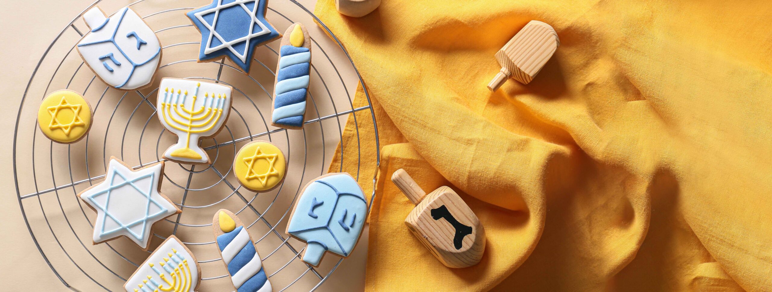 Hanukkah cookies on a cooling rack on a wood table 