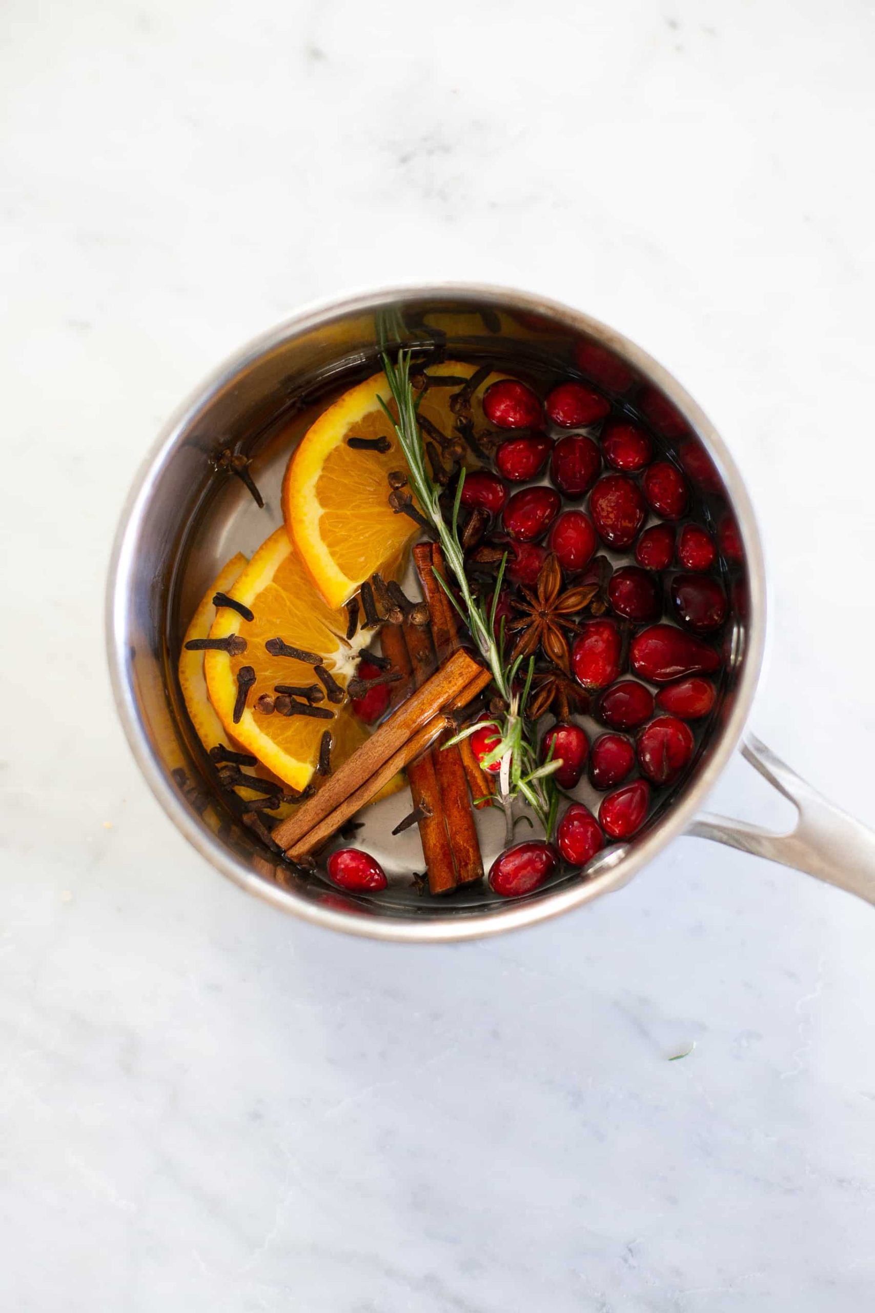 cinnamon, orange, cranberries, star anis in a simmering pot