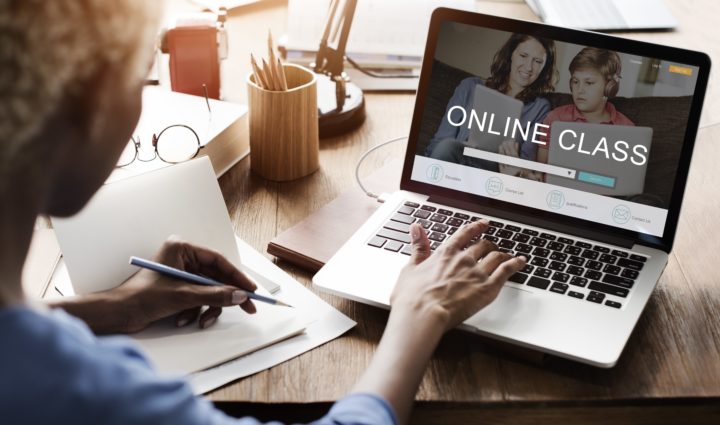 A woman sitting at her desk taking an online class