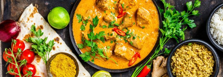 A curry meal displaying on a black table 