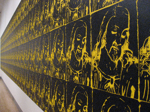 Andy Warhol print of Jesus in black and yellow across a huge wall