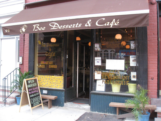 Bees Dessert & Cafe in Greenwich Village storefront with brown awning, brick structure and big glass windows