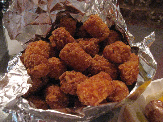 Crif Dogs NYC tater tots served in a aluminum basket and deep fried to a golden crisp.