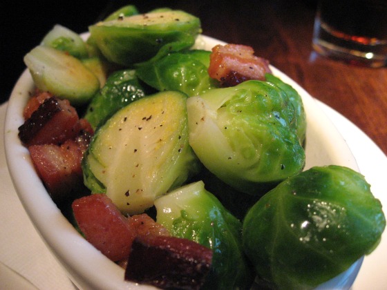 Brussel srpouts with fatty bacon at Burger & Barrel in Soho serves in a white oval dish